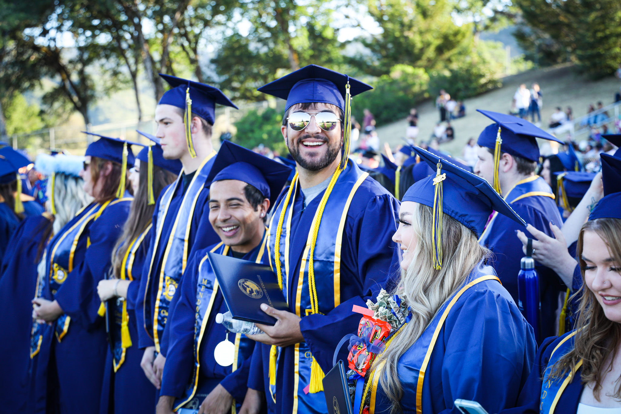 graduates smiling in blue robes