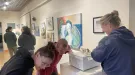 Viewers listen to dada-inspired sculpture at Student Show