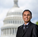 young man in front of white house dome