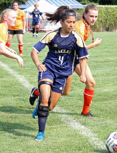 womens soccer player dribbling