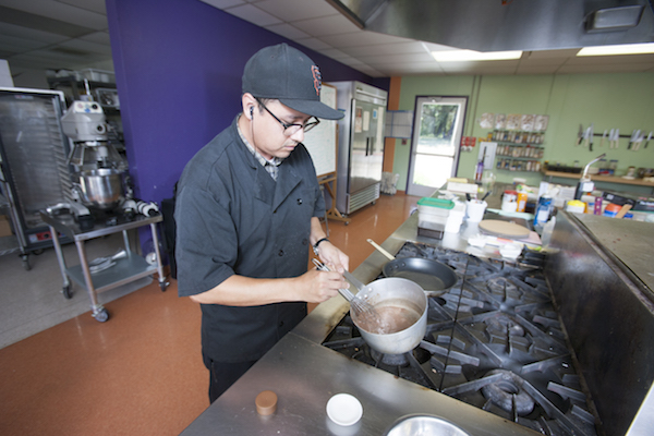 culinary student making sauce