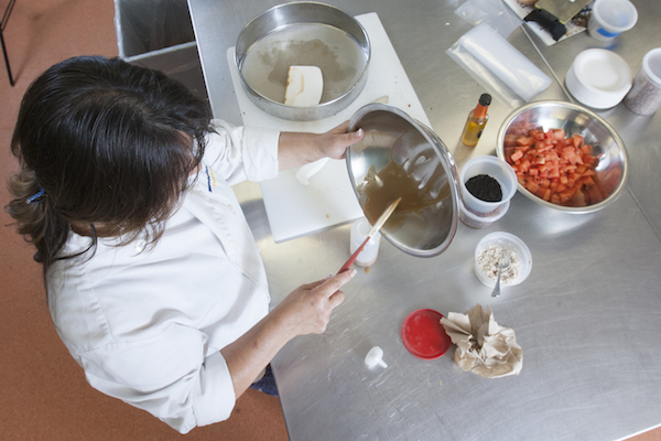 culinary student scraping sauce