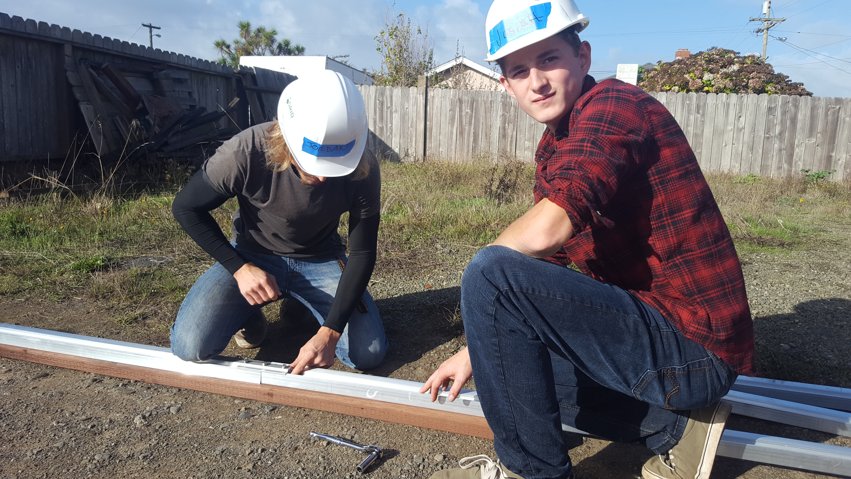 students prepare for solar panel installation