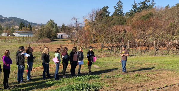 students standing in vineyard