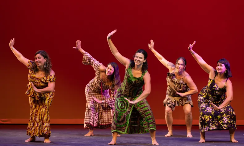 five women dancing with arms raised