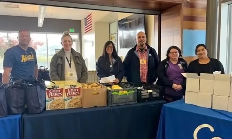 Staff giving out food from the Food Pantry in the Lowery Student Center.