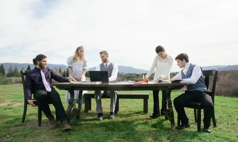 people sitting at table outside