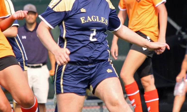 womens soccer player running