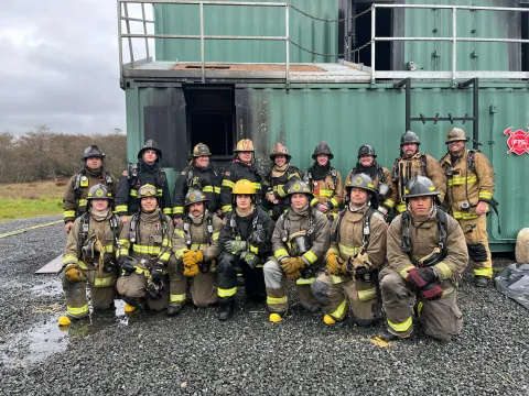 Fire Academy students at live fire training facility. 