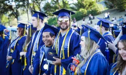 graduates smiling in blue robes