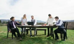 people sitting at table outside