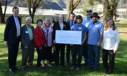 group photo with large check