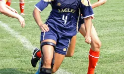 womens soccer player running