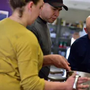 Chef instructor teaching students with bowls