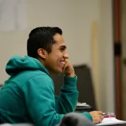 Young man student in class smiling