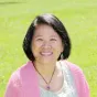 woman with black hair and pink sweater