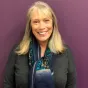 blonde woman in grey jacket